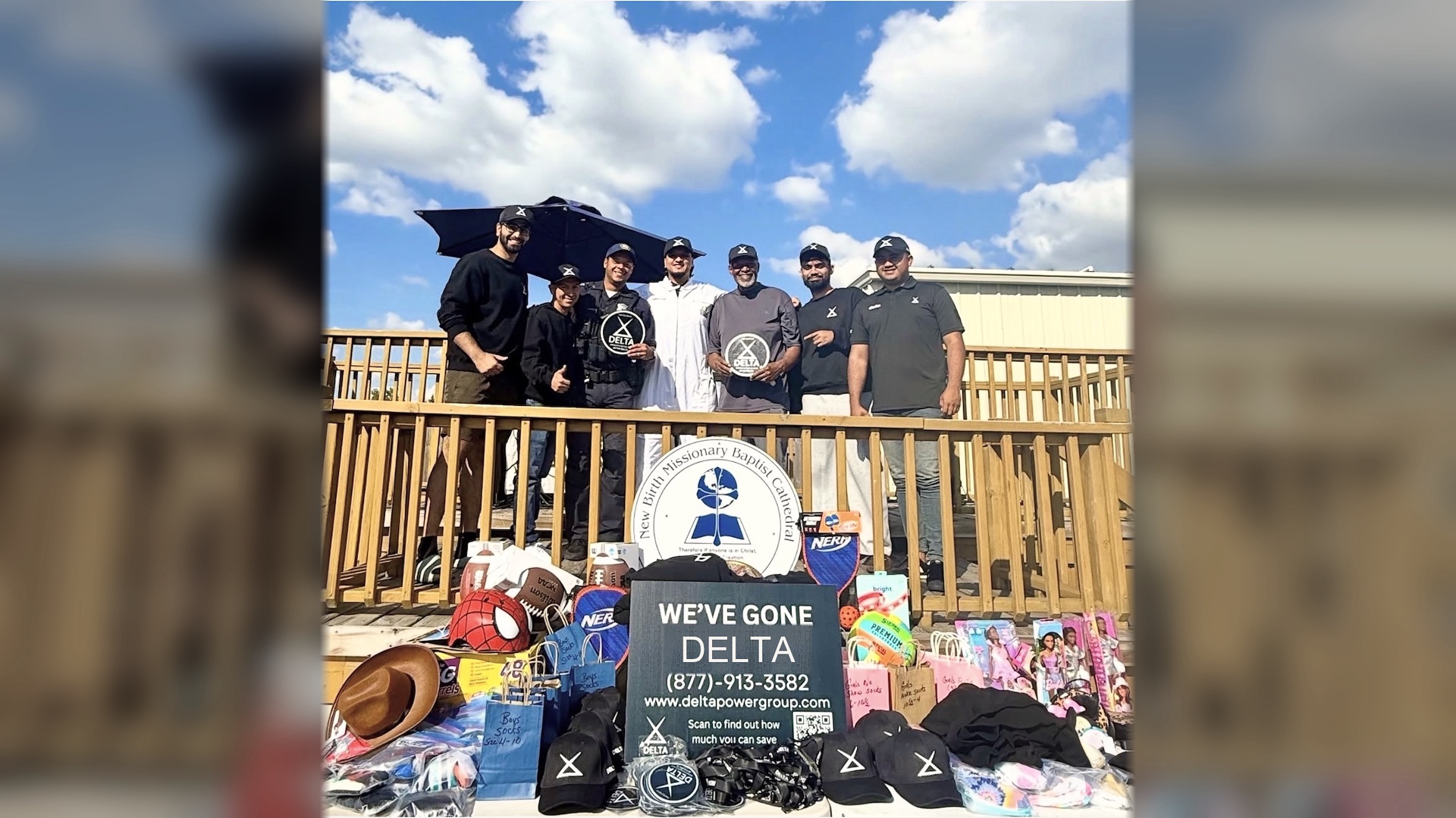 Delta Power Group team with a local police officer and community partners at a neighborhood donation drive