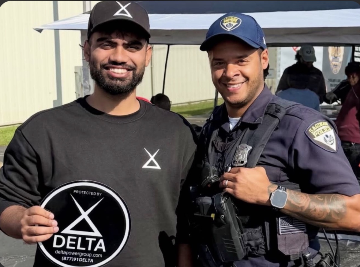 Delta Power Group with a Saginaw police officer at a community event